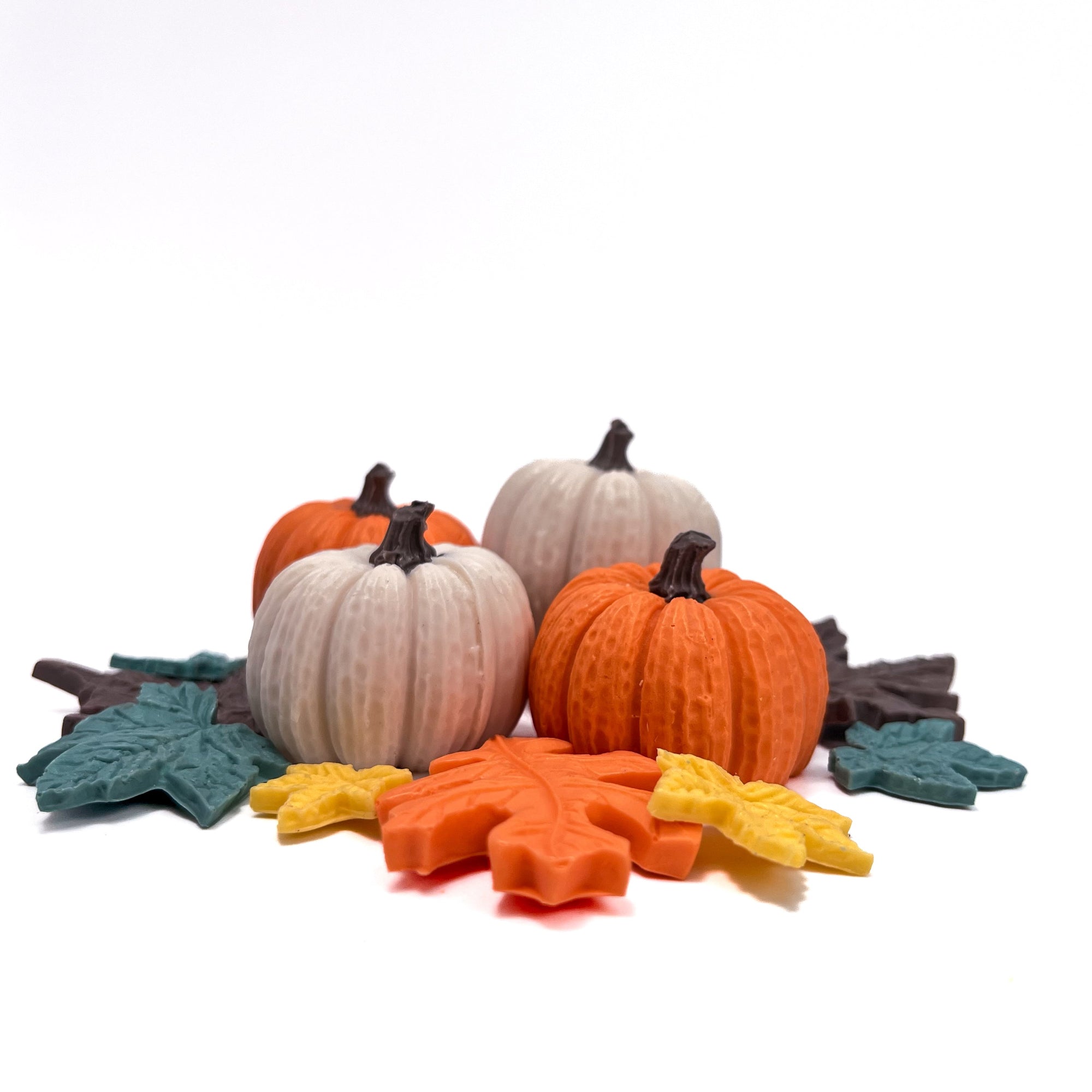 Decorative soap pumpkins and soap leaves on a white background 2 white pumpkins and two orange pumpkins hand made by rusted acre soap company.