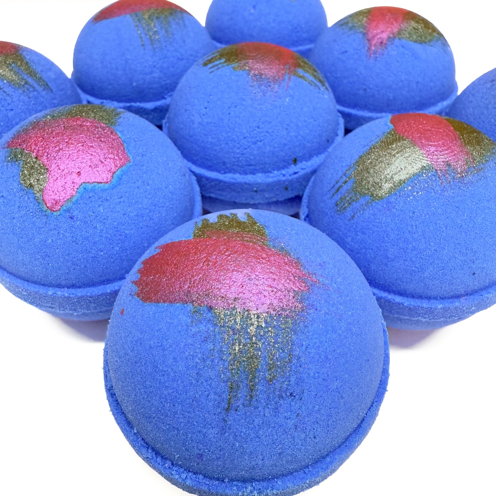 Multiple hand made round purple raspberry vanilla scented bath bombs with hand painted brush  strokes on top for detail. Made by Rusted Acre Soap Co.