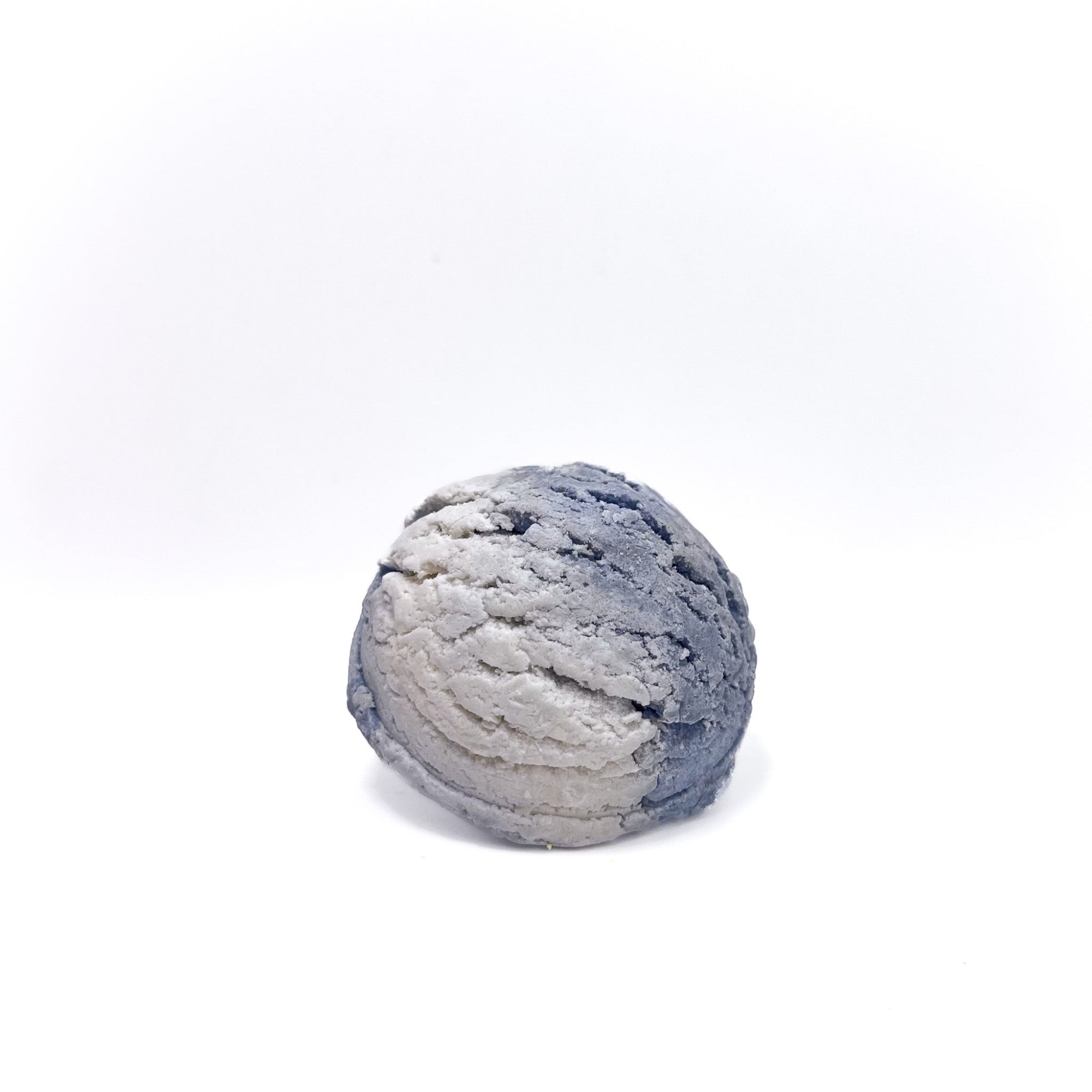 A scoop of lite blue and white swirled bubble bar shaped like a scoop of ice cream from Rusted Acre Soap Co.