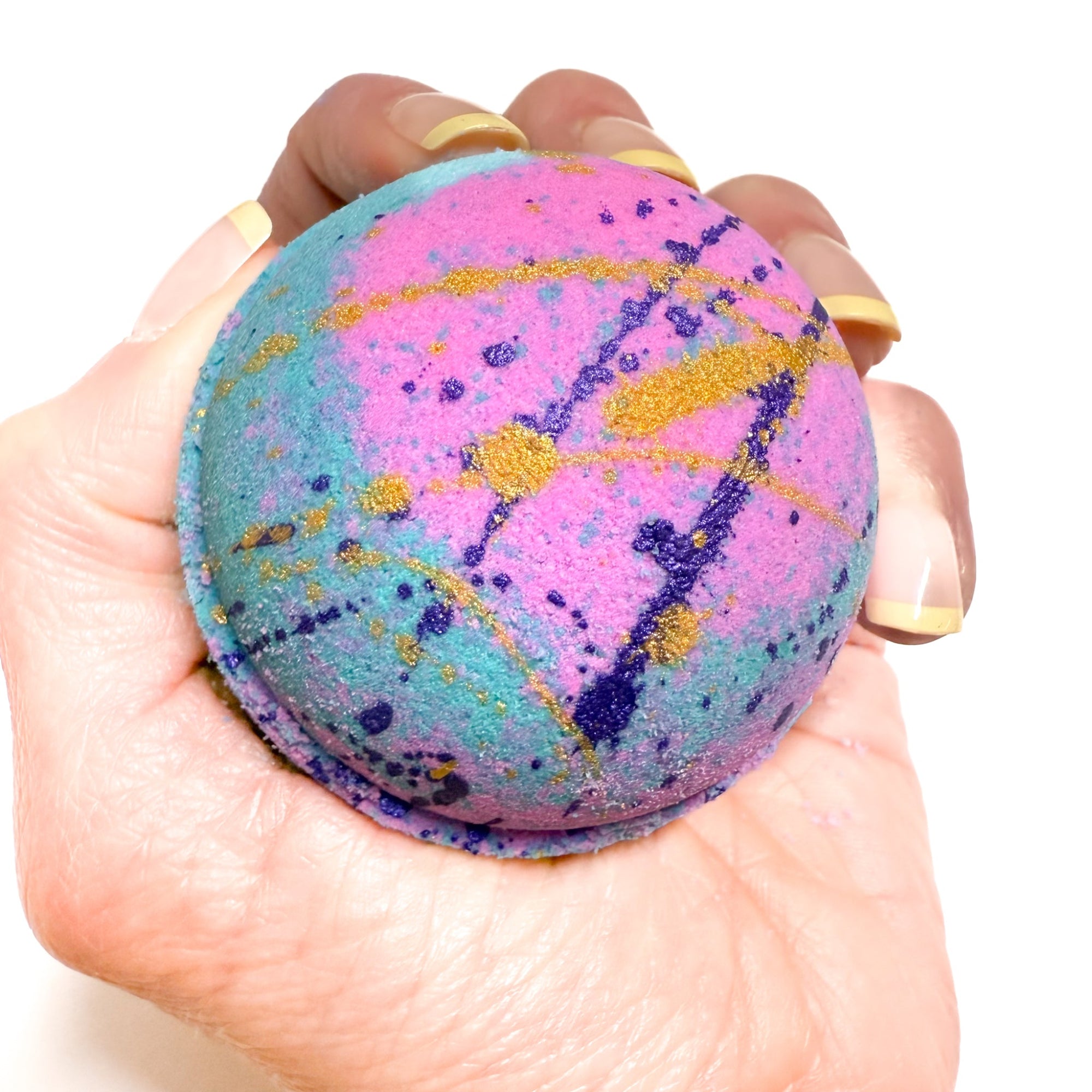 Pink and Teal bath bomb with purple and gold paint, made by Rusted Acre Soap Company. Scented with a beach aroma. 
