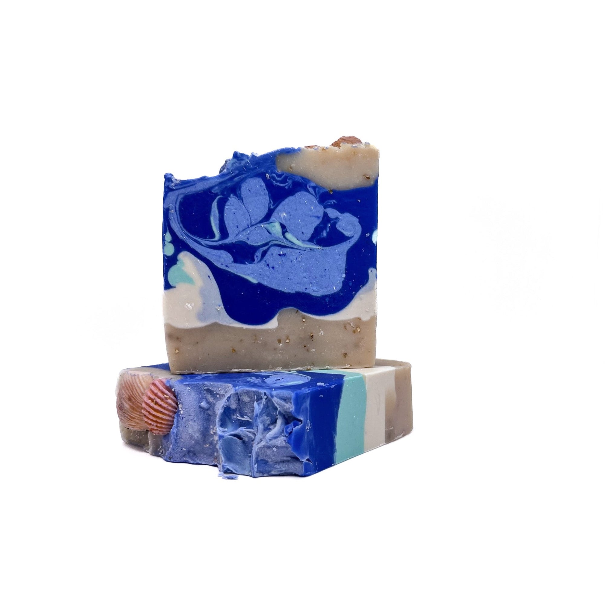 Two bars of Rusted Acre Soap Company's Sea Shell handmade soap. One flat and one upright. 