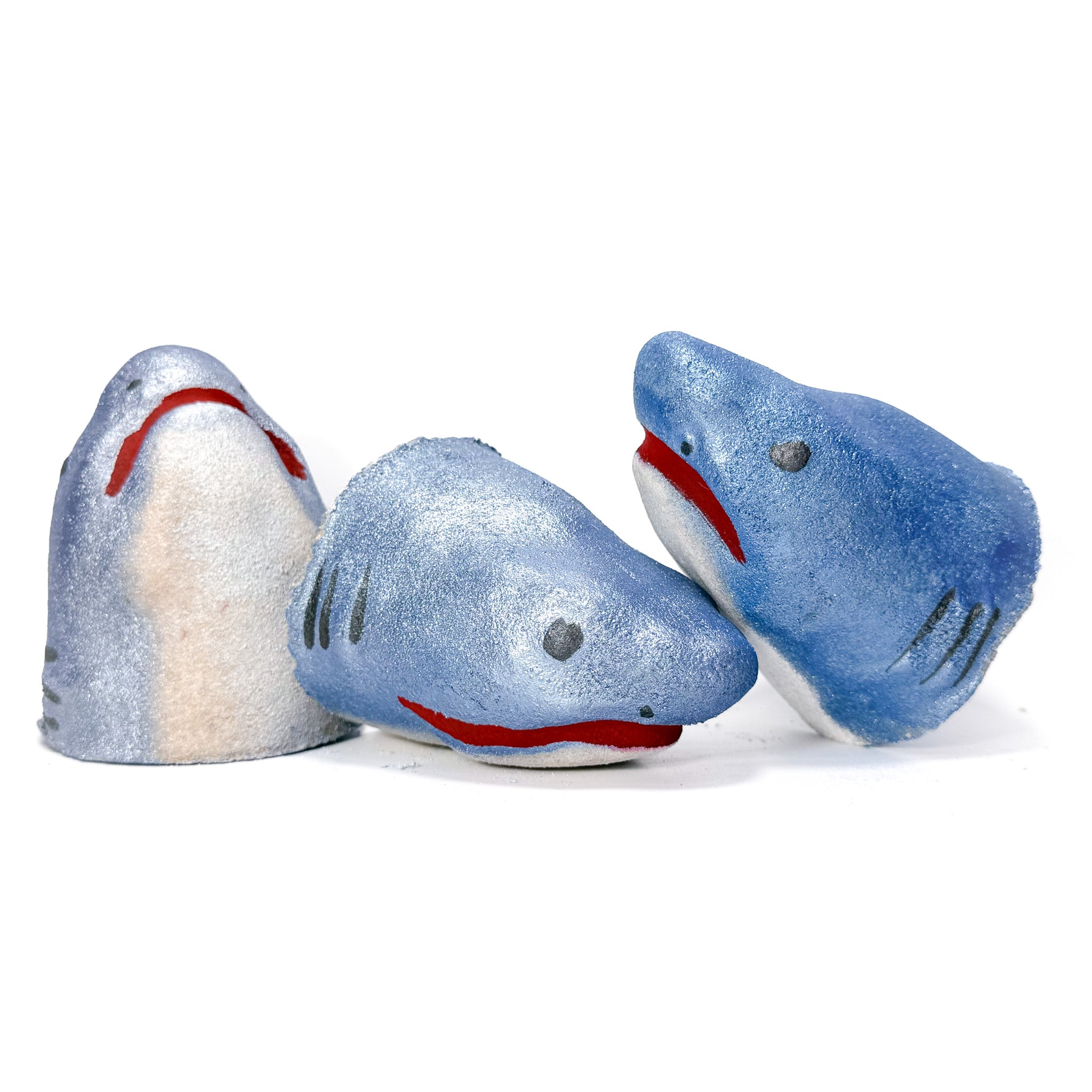 Three shark bath bombs front, side and underside view.