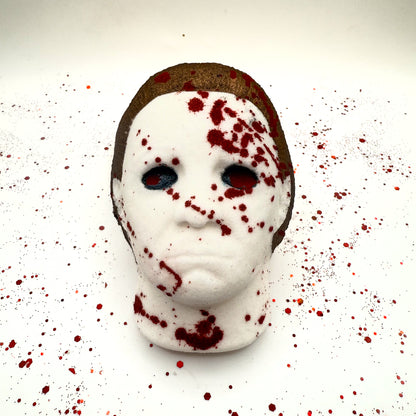 Front view of Silent Stalker horror bath bomb with intense blood splatter across the mask and background.
