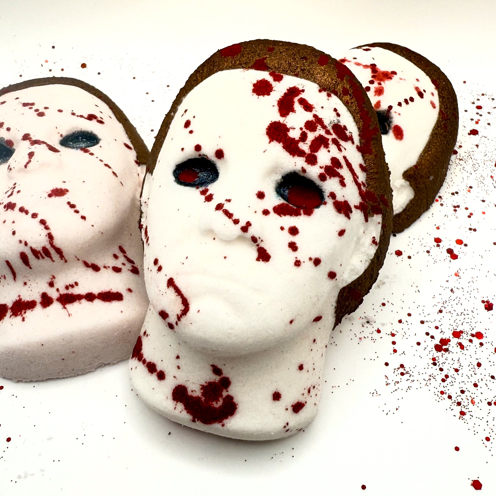 Close-up angle of Silent Stalker bath bombs showcasing hand-painted blood splatter and signature horror mask design.