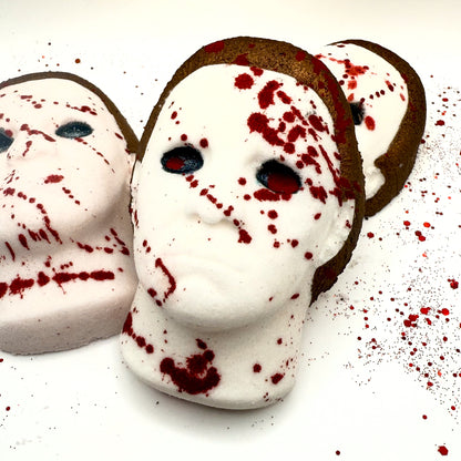 Close-up angle of Silent Stalker bath bombs showcasing hand-painted blood splatter and signature horror mask design.