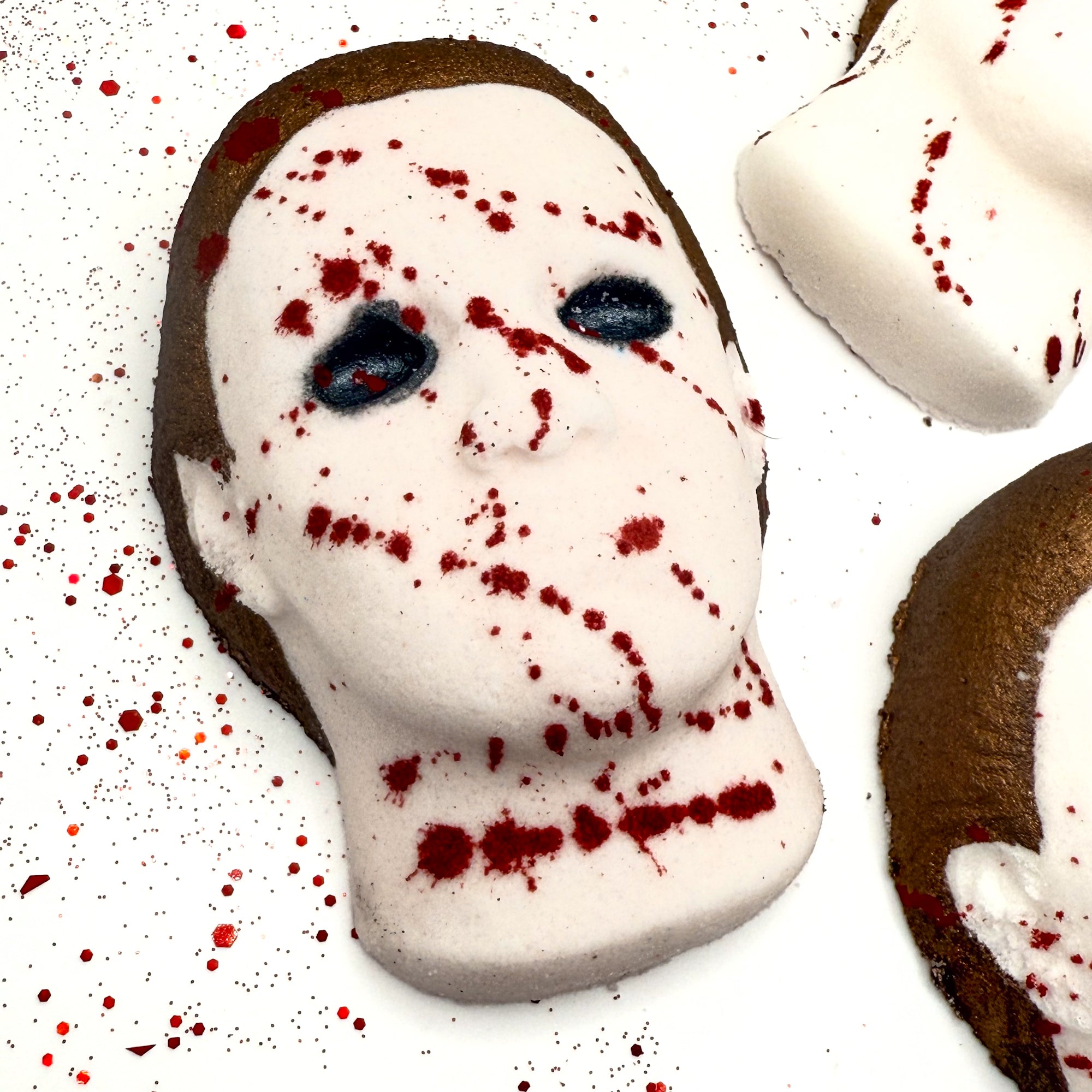 Silent Stalker bath bomb showing detailed facial features, brown hair accent, and red splatter design.