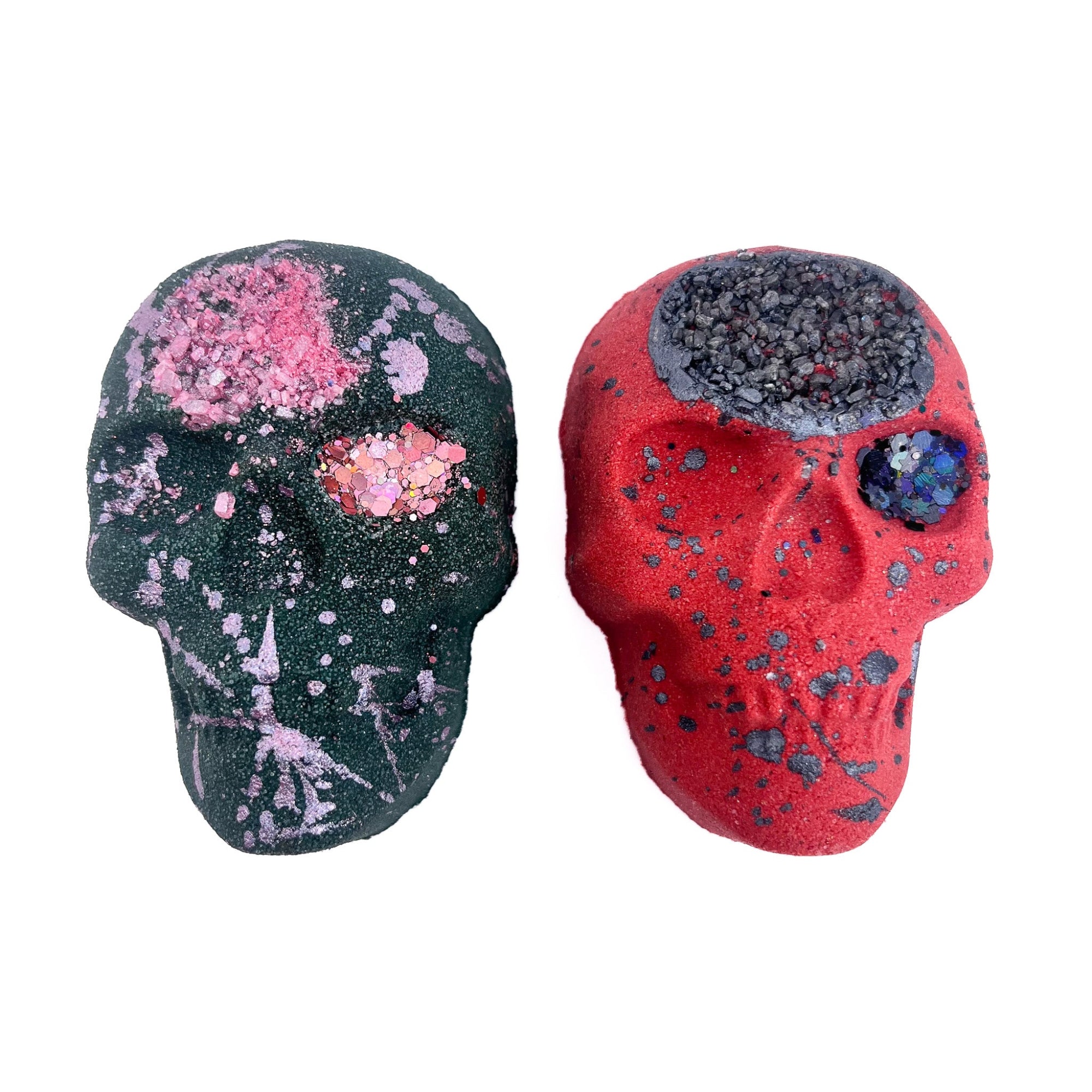 A red and a black skull shaped bath bomb from Rusted Acre Soap Co.