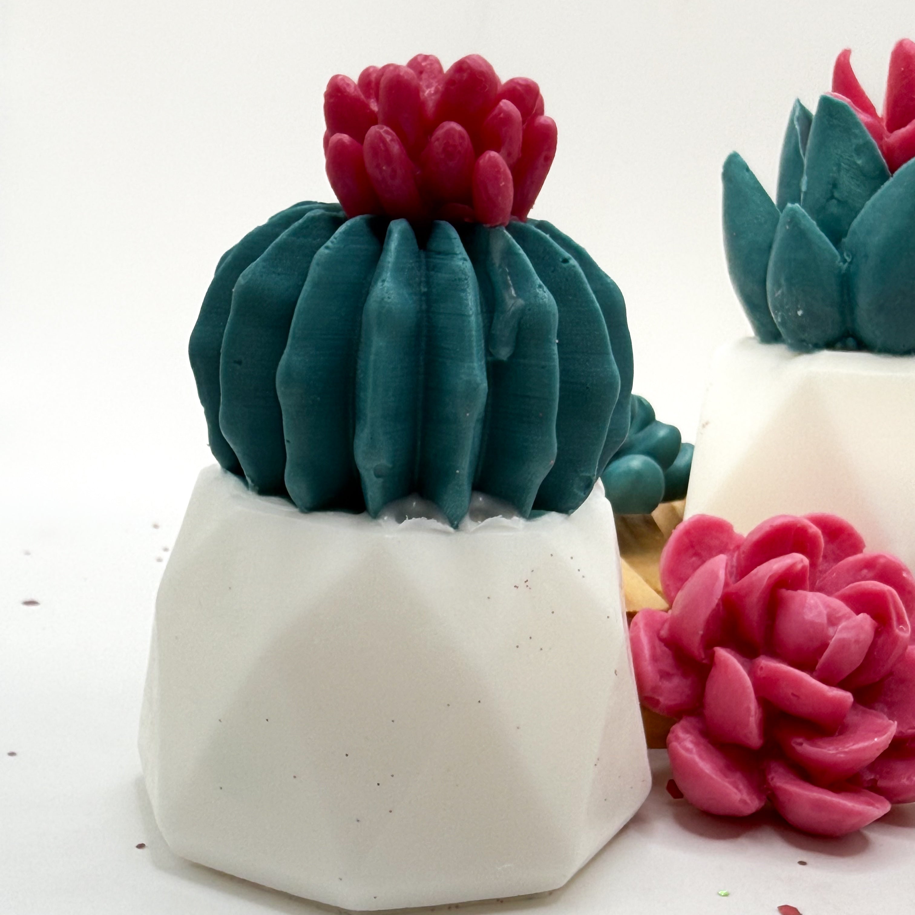 Decorative cactus soap with pink top in a white pot on a wooden surface handmade by Rusted Acre Soap Co.