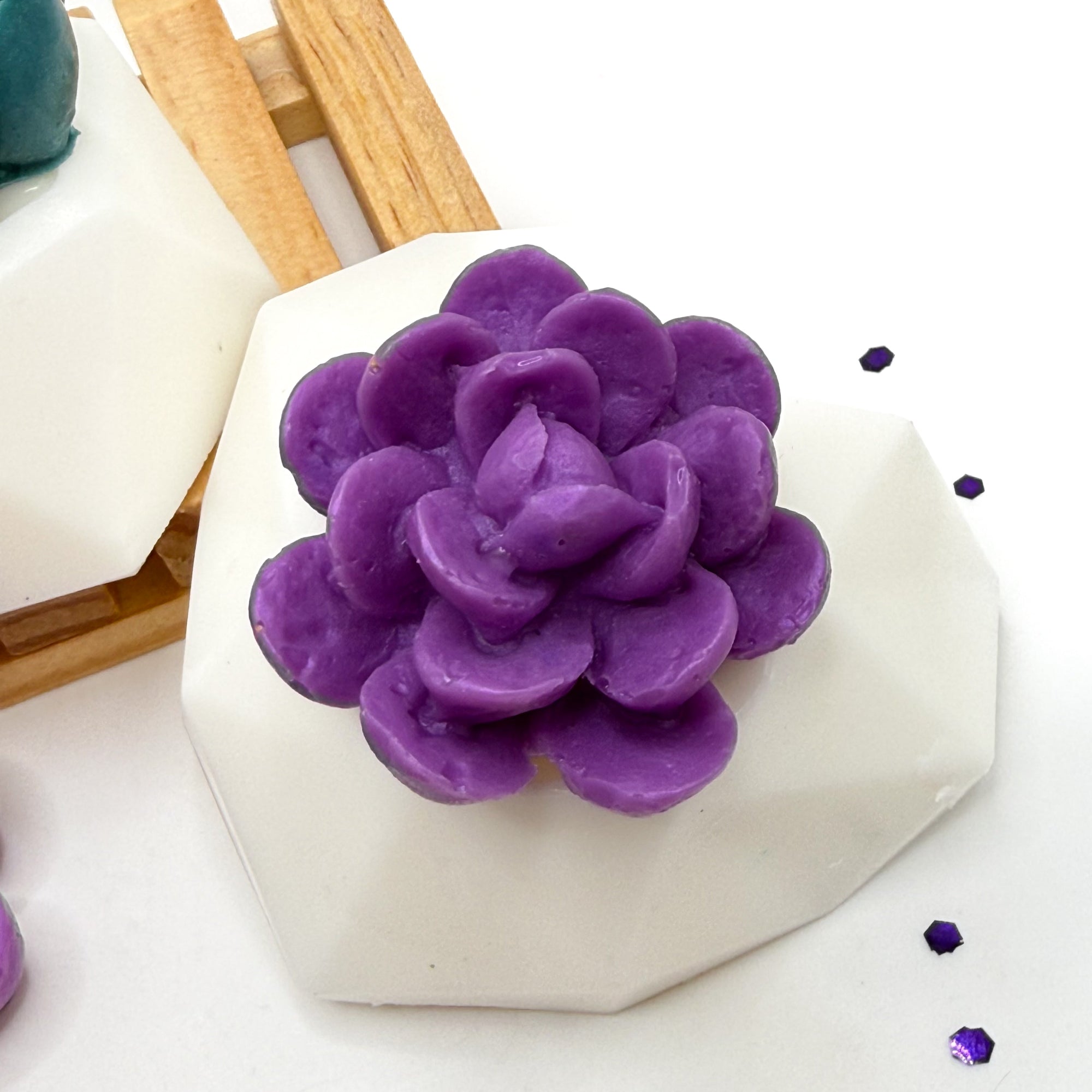 One broad leaf succulent soap with a purple flower and a white soap pot, handmade by Rusted Acre Soap Co. 