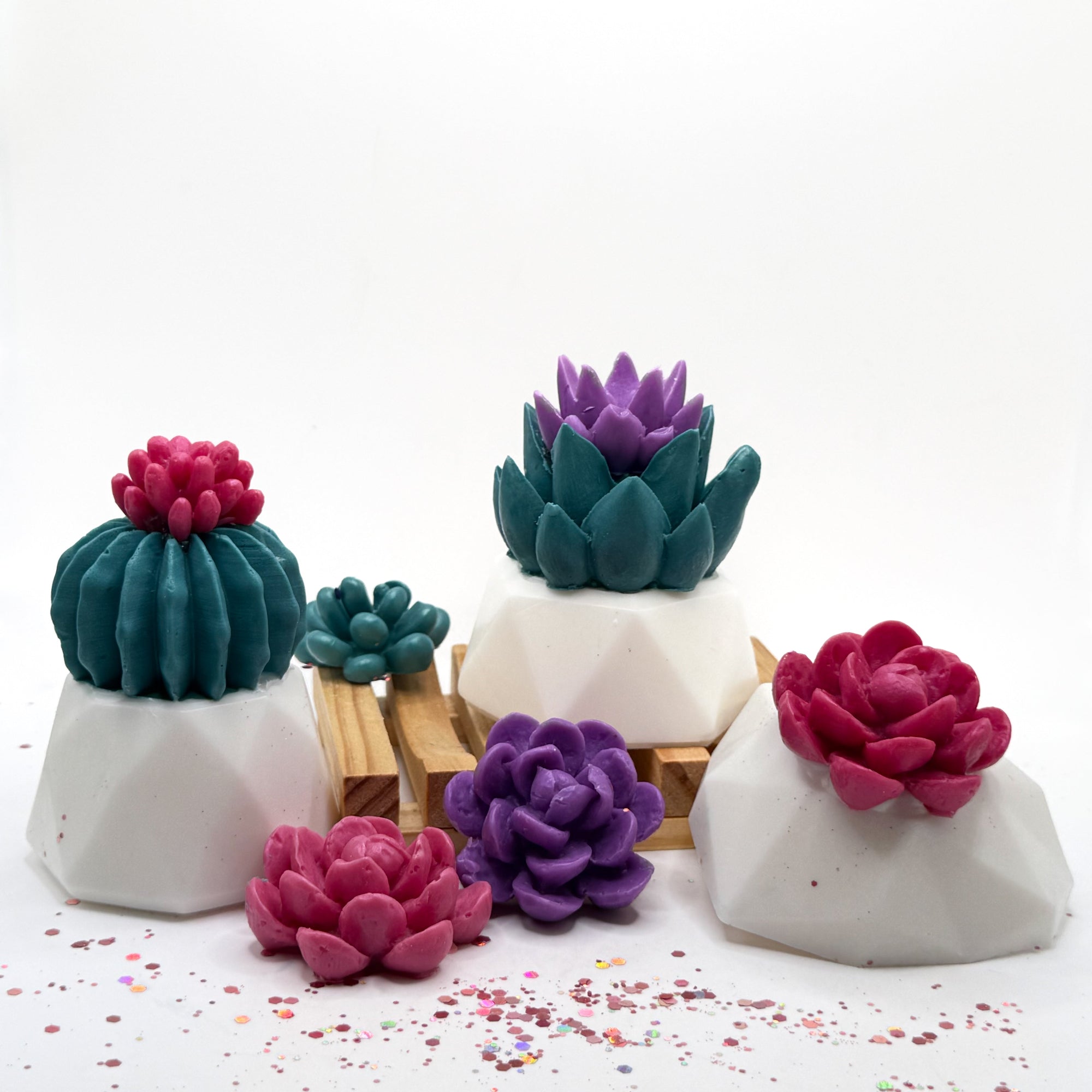 Set of succulent-shaped soaps with mixed color pink and purple flowers on a white background handmade by Rusted Acre Soap Co.