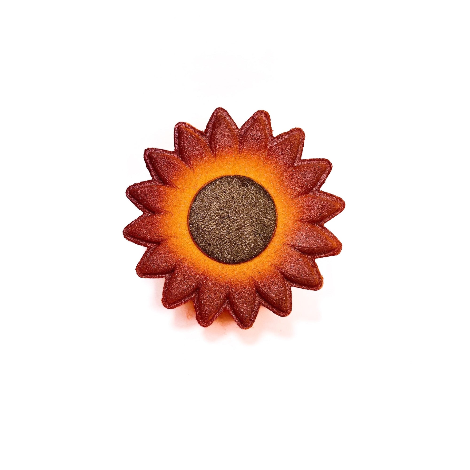 One sunflower bath bomb by Rusted Acre Soap Co. Hand-painted brown center like seeds. Yellow to orange gradient on petals. 