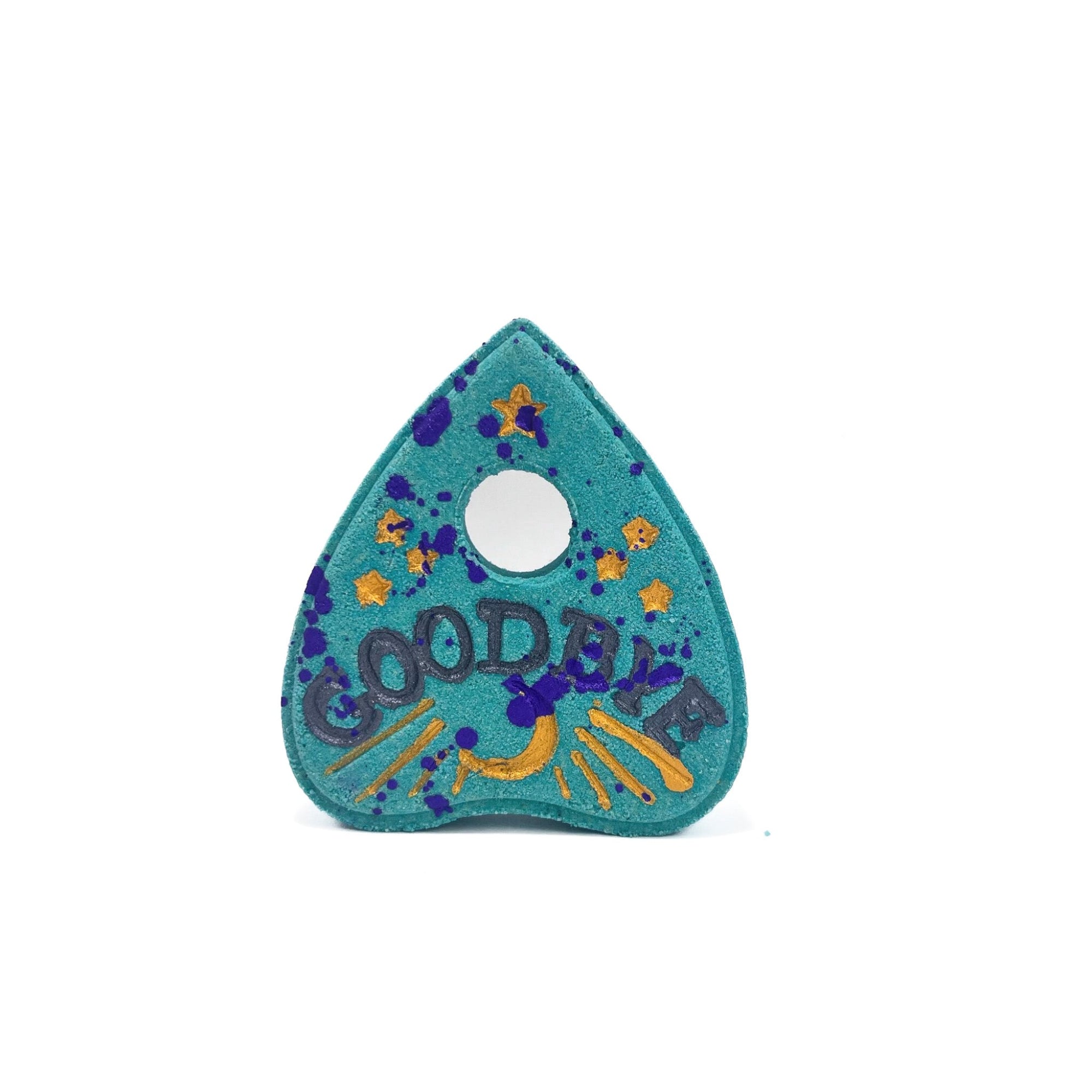 A teal planchette shaped bath bomb splattered with purple and gold mica. Hand-painted gold moon, black "GOODBYE".