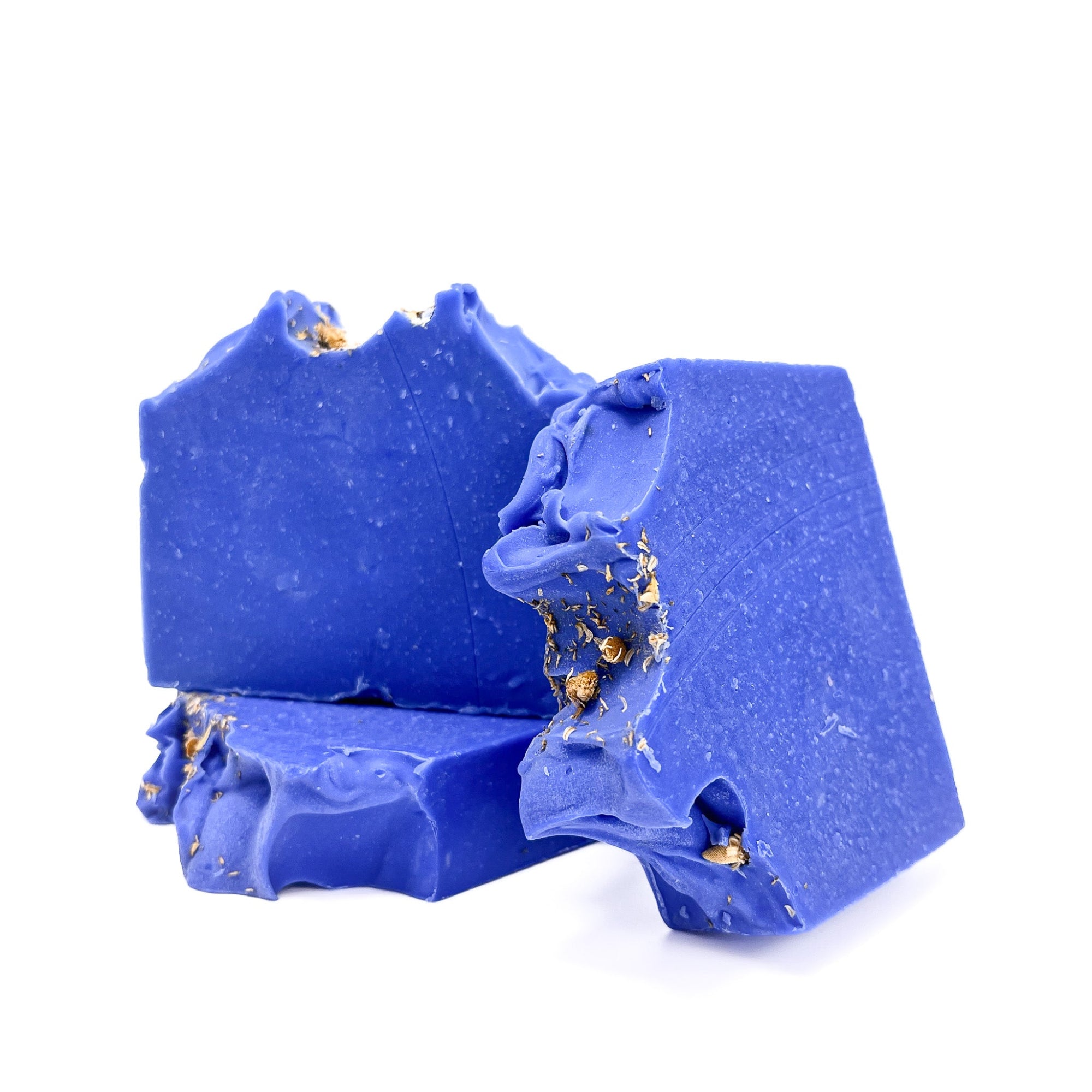 Three bars of beautiful indigo blue handmade soap from Rusted Acre Soap Co. One flat, two upright to show texture.