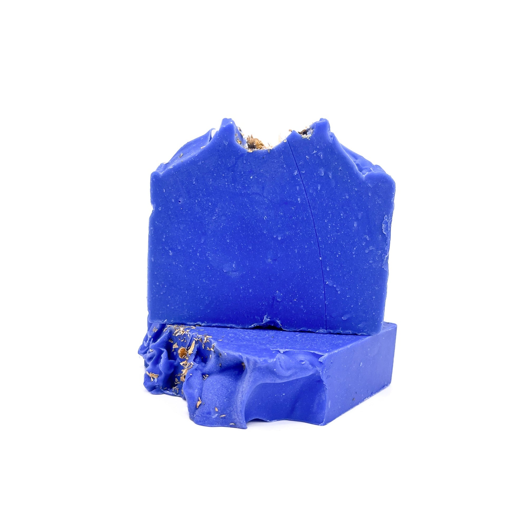 Two bars of indigo blue handmade soap from Rusted Acre Soap Co. One flat, one upright to show texture.