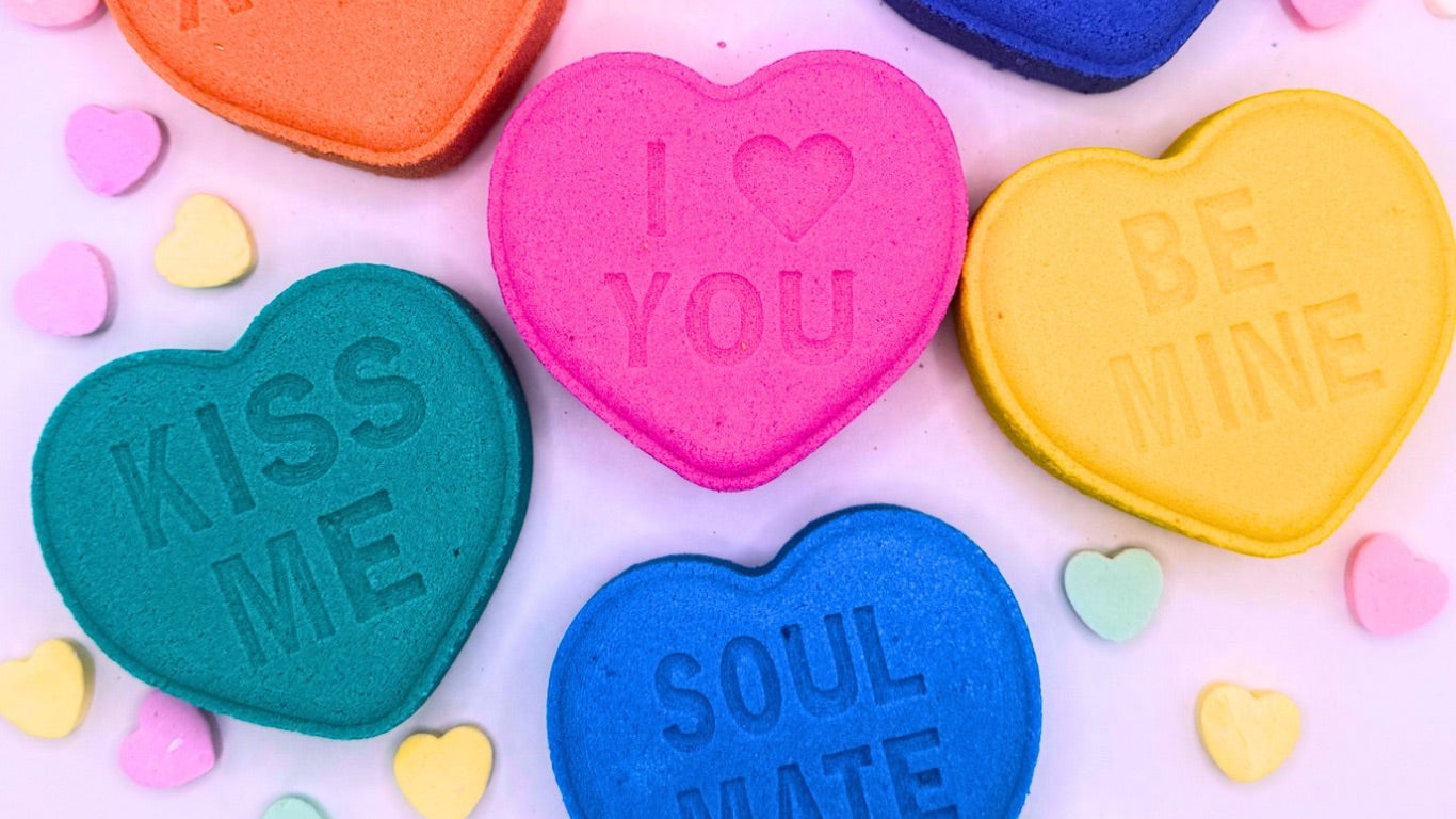 Rusted Acre Soap Company's Valentine's hero image. Multiple heart bath bombs with sayings visible. 
