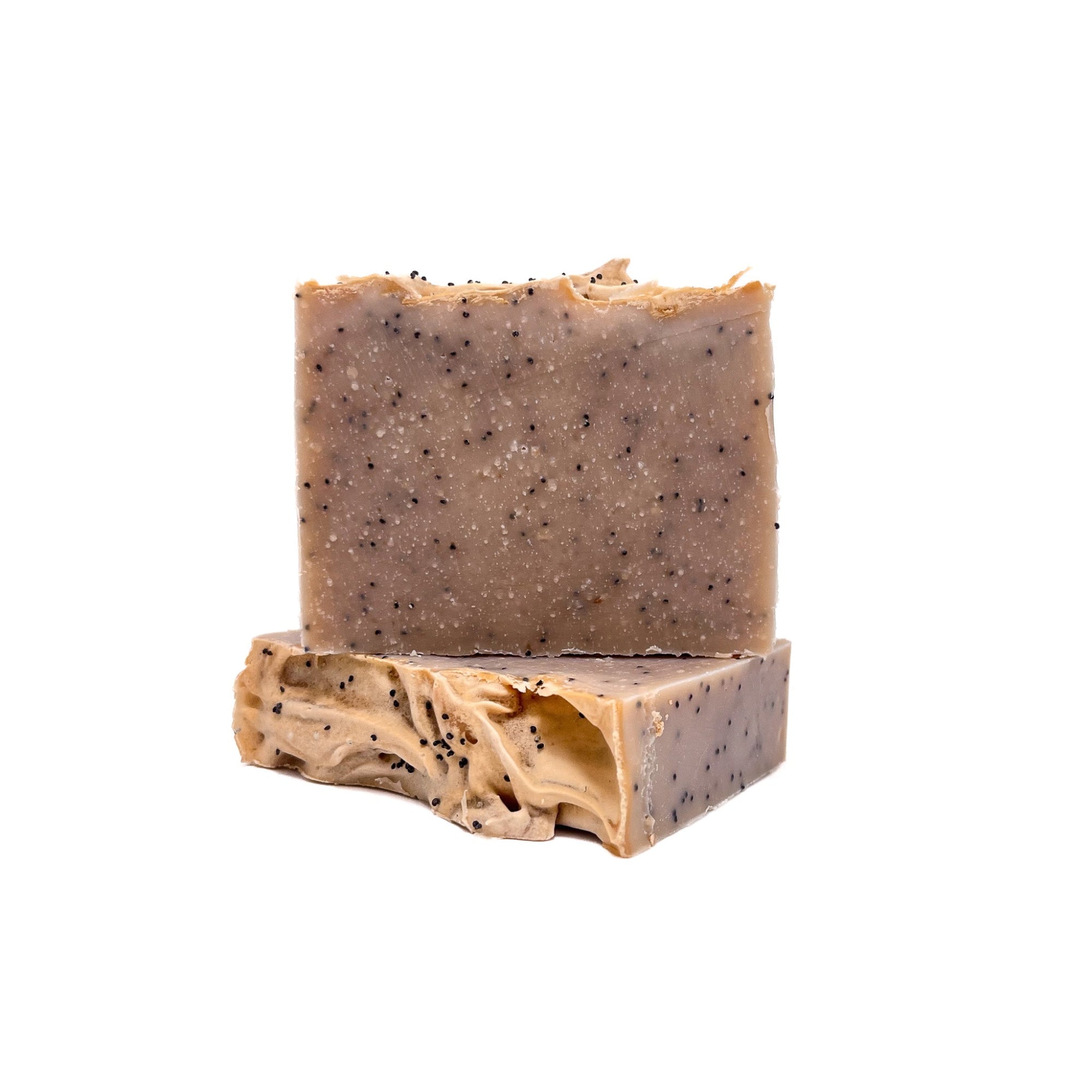 Two bars of Rusted Acre Soap Company's vanilla bean handmade soap beige in color with vanilla bean speck throughout.
