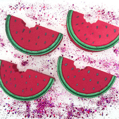 Four watermelon slice bath bombs  on a colorful glitter background