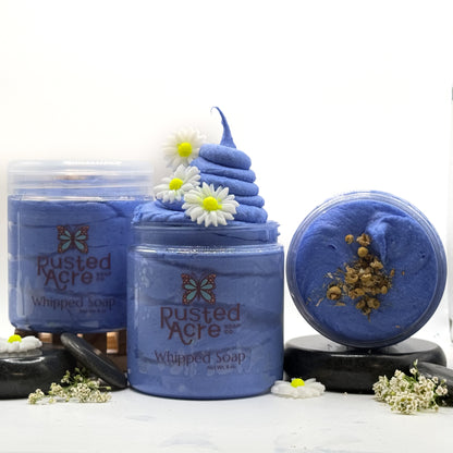 Three jars of blue tranquility whipped soap made by Rusted Acre Soap Co with spa type props. 
