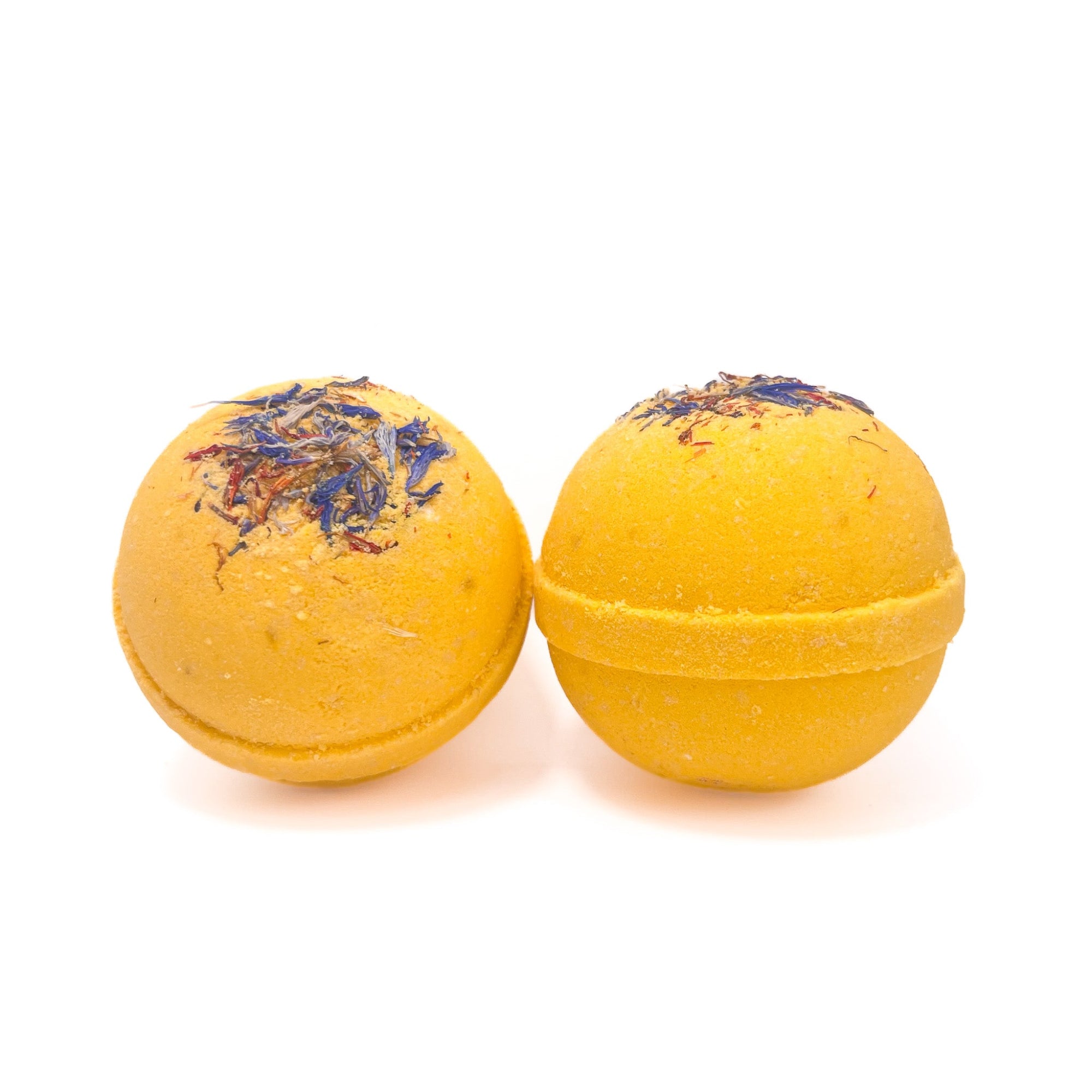 Two round yellow wildflower and honey bath bombs from Rusted Acre Soap Company.