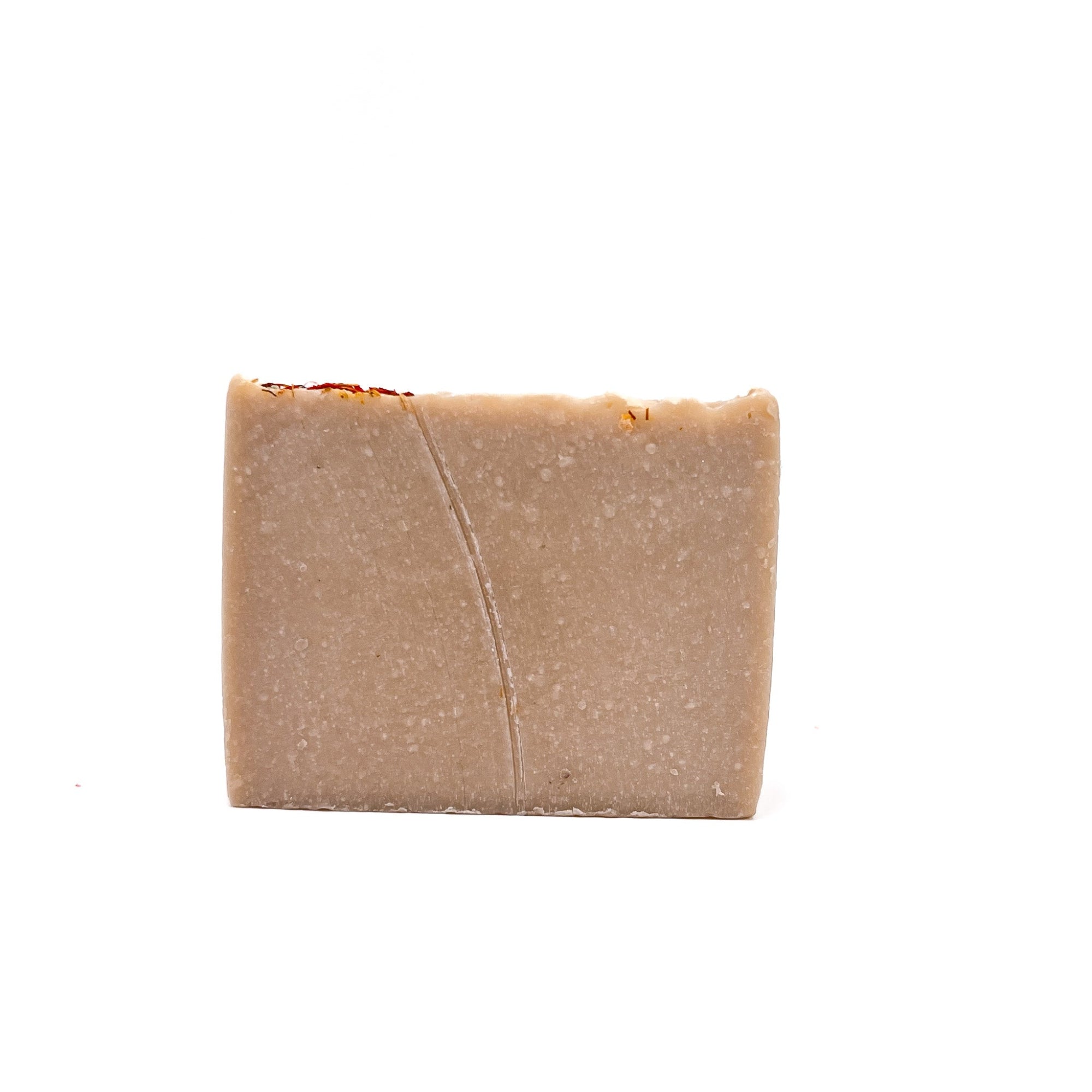 A bar of natural colored handmade bar soap scented with wildflower and honey by Rusted Acre Soap Co.