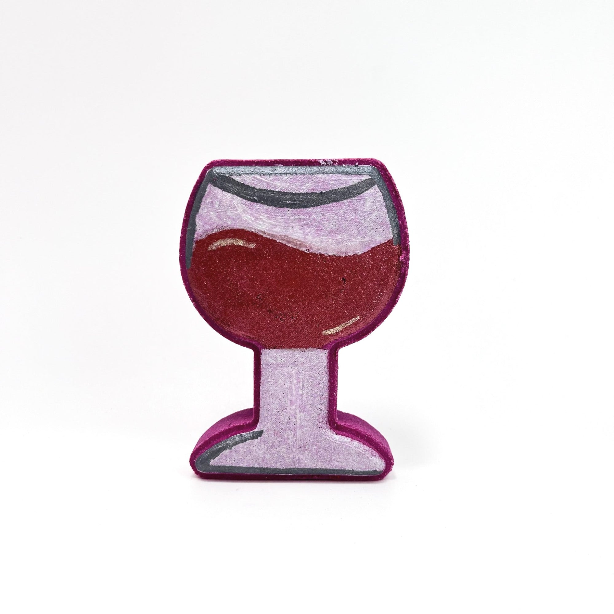 Burgundy colored bath bomb with hand-painted silver stem and gray accent. The wine is hand-painted deep burgundy with illusion of swirling in the glass. Displayed on a rustic wooden background.  
