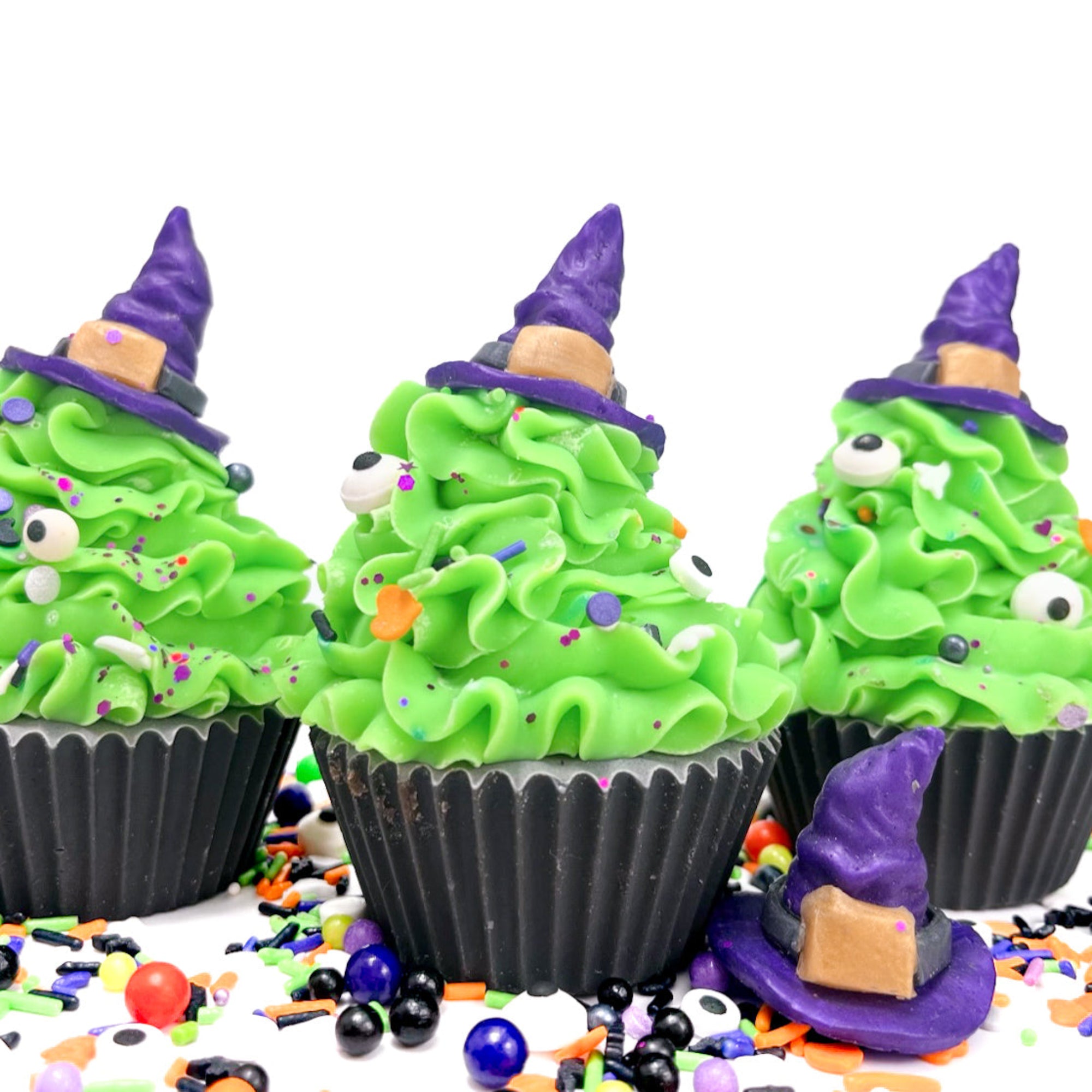 Three cupcake soaps with witches hats on top handmade by Rusted Acre Soap Co